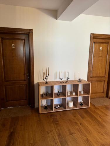 a room with two doors and a shelf with shoes at Pensiunea Magic in Băile Govora