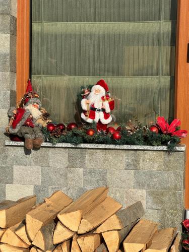 a window with santa claus decorations on a mantle at Pensiunea Magic in Băile Govora