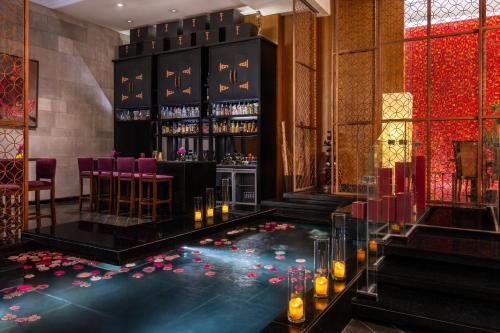 a lobby with a bar with candles on the floor at Sofitel Cairo Downtown Nile in Cairo