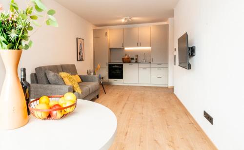 a living room with a bowl of fruit on a table at AmRain Ferienwohnungen in Altusried