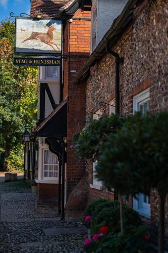 a sign on the side of a brick building at The Stag and Huntsman at Hambleden in Henley on Thames