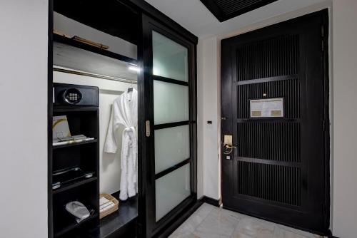 a walk in closet with a black door at Pearl Continental Hotel, Muzaffarabad in Muzaffarabad
