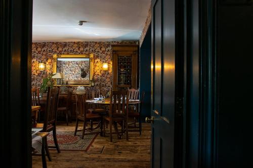 a dining room with a table and chairs at The Stag and Huntsman at Hambleden in Henley on Thames
