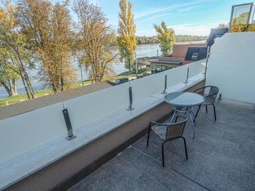 a balcony with a table and chairs on a building at Holiday Beach Budapest Wellness Hotel with Sauna Park in Budapest
