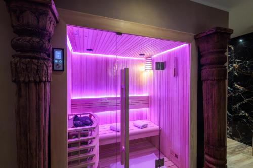 a pink shower with a pink lighting in a room at pampa-chambre-hote et spa in Warhem