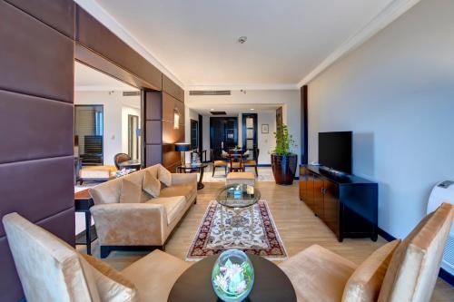 a living room with a couch and a table at Pearl Continental Hotel, Muzaffarabad in Muzaffarabad