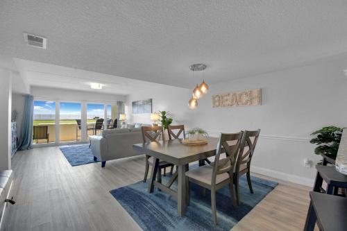 a dining room and living room with a table and chairs at Ocean Front Condo With Pool Ground Floor in St. Augustine