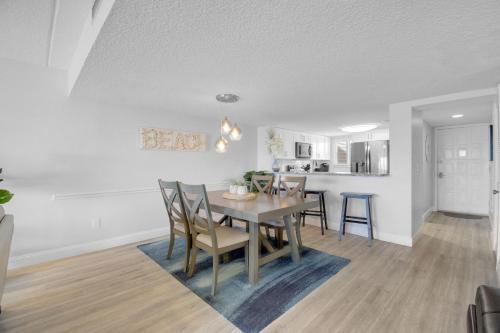 a dining room and kitchen with a table and chairs at Ocean Front Condo With Pool Ground Floor in St. Augustine