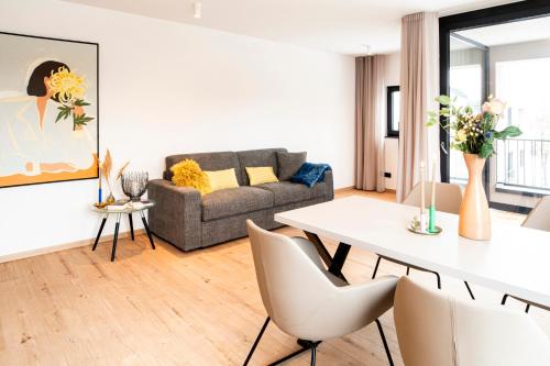 a living room with a couch and a table at AmRain Ferienwohnungen in Altusried