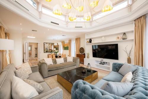 a living room with couches and a tv at Fountain House Apartments - Hyde Park, London in London