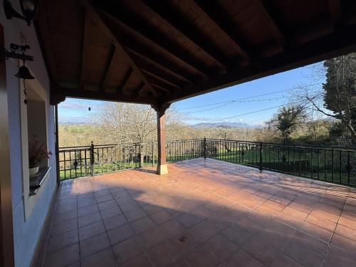 a screened porch with a view of the mountains at La Casa Azul 1 en Asturias in Nava