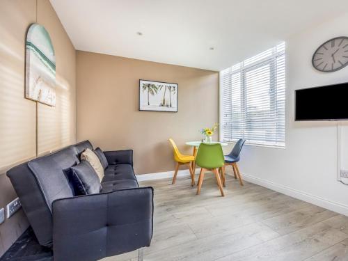 a living room with a couch and a table at Contemporary Modern Studio in Portsmouth