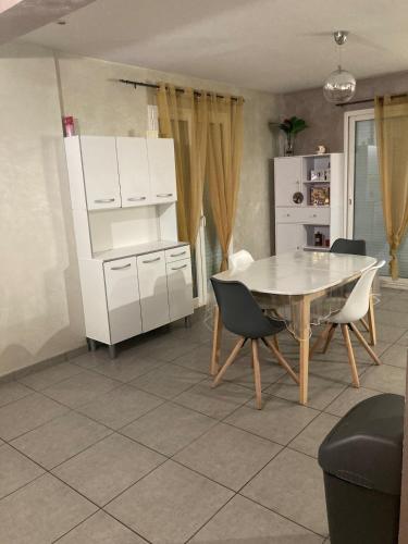 une cuisine avec une table et des chaises dans une pièce dans l'établissement Maison tout confort 6 personnes wifi parking, à Colomiers