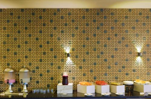 a table with plates of food on a wall at The Grand Retreat - Chikmagalur in Chikmagalūr