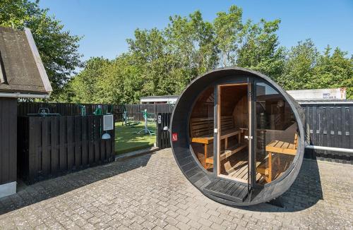 a circular building with a door in a yard at First Camp Holbæk Fjord in Holbæk