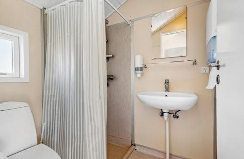 a bathroom with a toilet and a sink at First Camp Holbæk Fjord in Holbæk