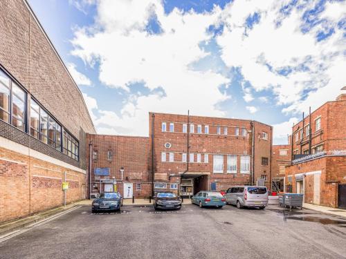 a parking lot with cars parked in front of buildings at Trendy Studio Apartment in Portsmouth