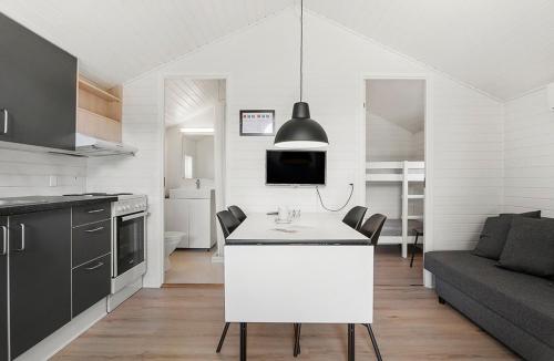 a kitchen and living room with a white island in a room at First Camp Holbæk Fjord in Holbæk