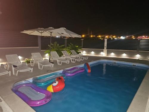 a swimming pool with a toy in the middle at Villa AS MOON with pool in Split
