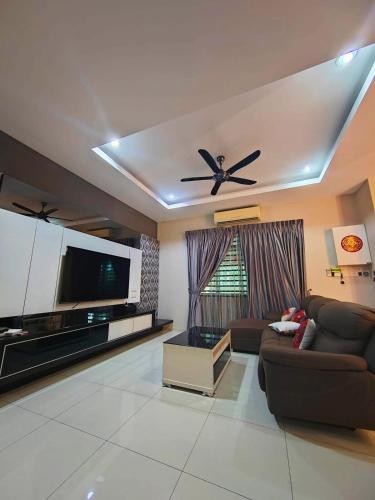 a living room with a couch and a ceiling fan at Muar 1Malaysia Homestay in Muar