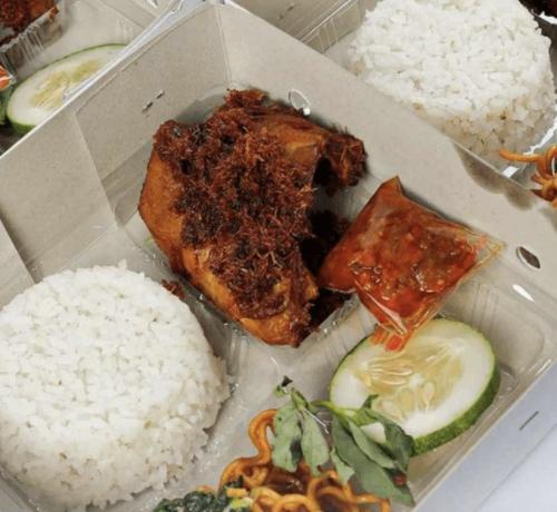 a box of food with rice and meat and vegetables at vanderman land camp in Batu