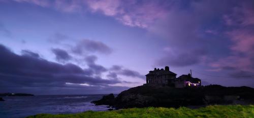 a house on top of a island in the ocean at Morlun, Trearddur Bay, Isle of Anglesey in Trearddur
