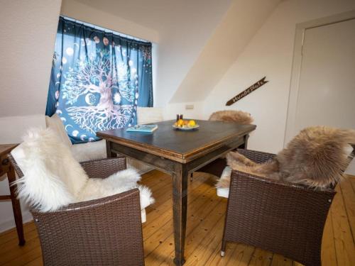 a dining room with a table and two chairs at 194 Fewo Dat LütjeHuus mit Dachterrasse im ersten Stock in Lütjenburg