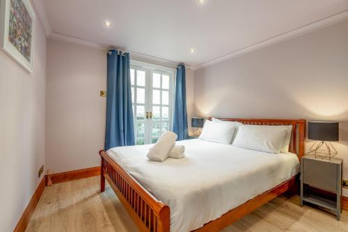 a bedroom with a large bed and a window at Poetry Peter's in Anstruther