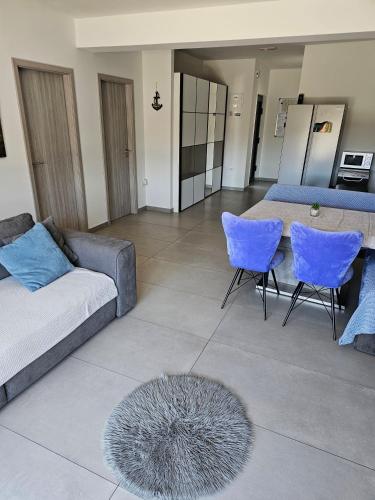 a living room with a couch and a table and chairs at Villa AS MOON with pool in Split