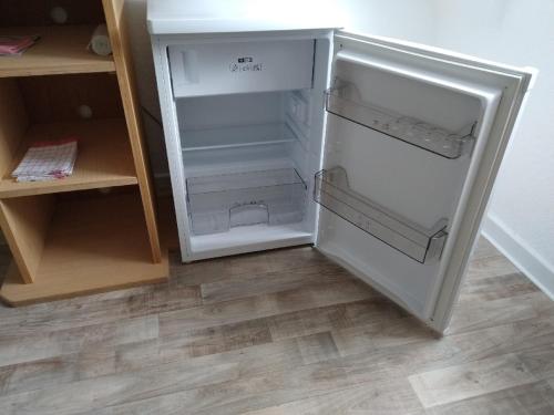 a white refrigerator with its door open in a kitchen at FeWo 12 45qm bis 3 Pers nahe Winterberg in Schmallenberg