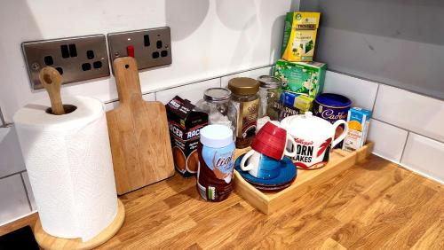a kitchen counter with a shelf with food and a roll of paper towels at West Kirby Apartment in West Kirby