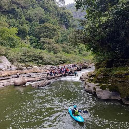 a group of people on a river in a canoe at Botón de oro hostal in San Agustín