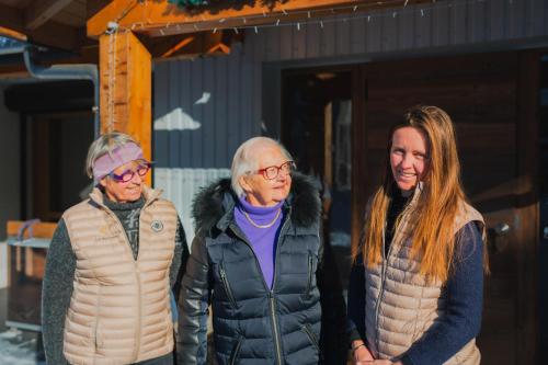 a group of three people standing in front of a building at Les Berlicants in Mijoux