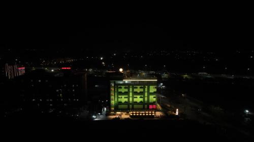 a lit up building at night in a city at Ramee Tarang Hotel Indore in Indore