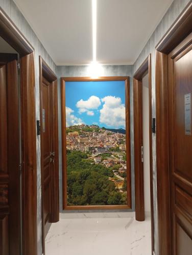 a room with a window with a view of a city at Morcone B&B Affittacamere in Morcone