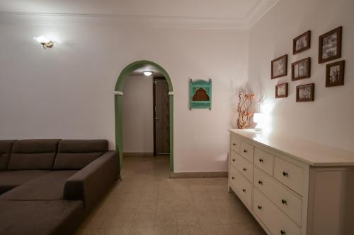 a living room with a couch and a dresser at Snore Summore, Hostel in Koramangala in Bengaluru
