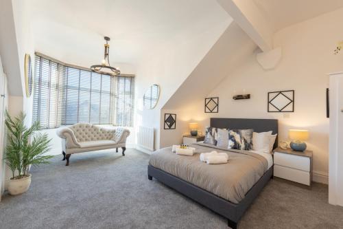 a bedroom with a bed and a chair at Richmond Retreat - Luxurious and comfortable spacious 2 floor apartment in Manchester