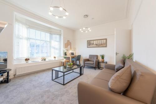 a living room with a couch and a table at Richmond Retreat - Luxurious and comfortable spacious 2 floor apartment in Manchester