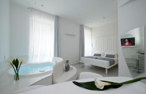 a white room with a bed and a sink at Gatto Bianco Mia Aparthotel in Milan