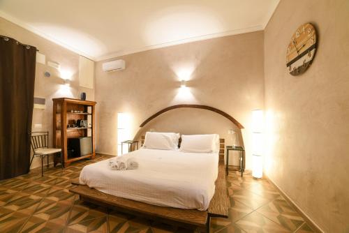 a bedroom with a large white bed in a room at Al Console Depandance con jacuzzi per coppia in Monopoli