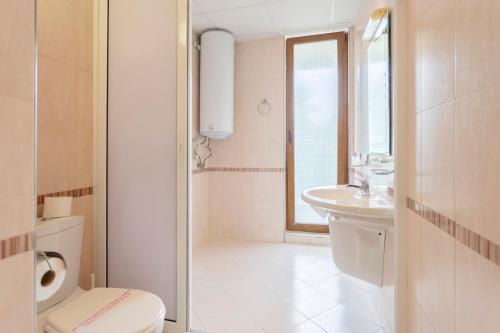 a bathroom with a shower and a toilet and a sink at Aparthotel Hotel Prestige City II in Primorsko