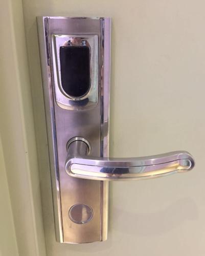 a metal door handle on a white door at 888 Boutique Hotel in Batu Pahat