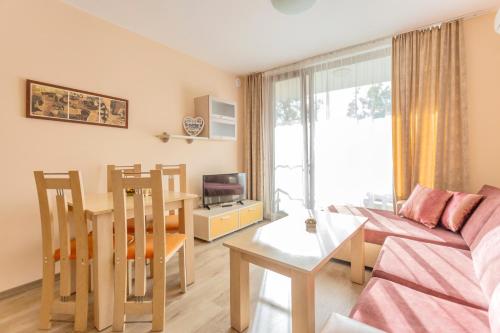 a living room with a couch and a table at Aparthotel Hotel Prestige City II in Primorsko