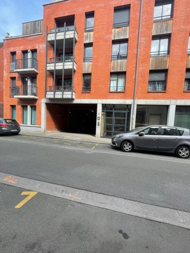 a gray car parked in front of a brick building at Chez Armando - Lille Centre in Lille