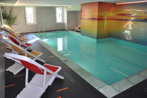 a swimming pool with chairs and a swimming pool at Liberty Hotel Malé in Malè