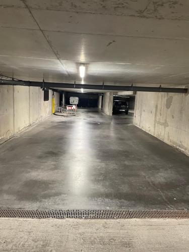 an empty parking garage with a car parked in it at Chez Armando - Lille Centre in Lille