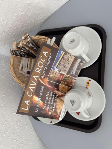 a book on a tray with a magazine and plates at Hotel Panda in Pas de la Casa