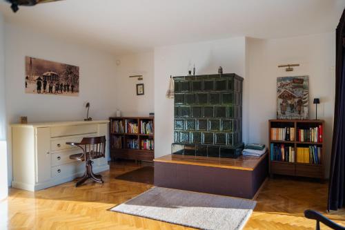 a room with a book shelf and a desk with books at CASA NATURA - charming chalet with hot tub in Tuk Vojni