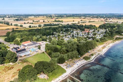 an aerial view of a resort next to the water at First Camp Bøsøre Strand Feriepark in Hesselager