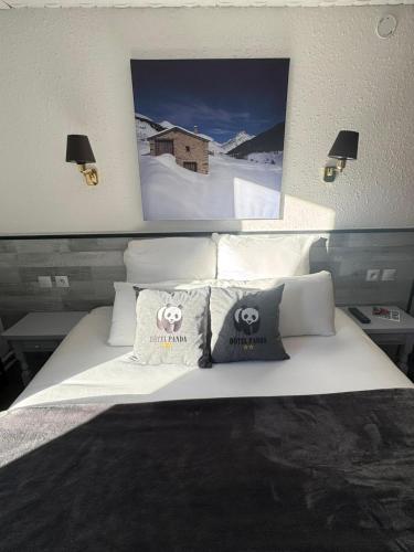 a bedroom with a white bed with pillows on it at Hotel Panda in Pas de la Casa